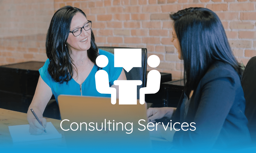Two women sitting at a desk with the words consulting services.